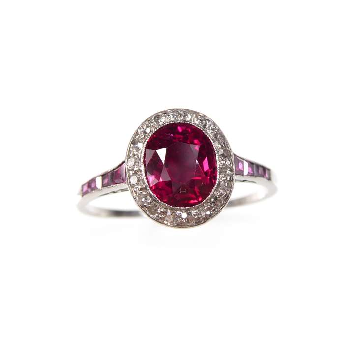 Ruby and diamond cluster ring with a central oval cut Burma ruby